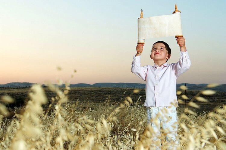 2_kid-holding-a-torah-scroll-9994810